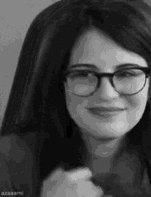 a black and white photo of a woman wearing glasses