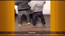 a video of two men dancing with the words drop that on the bottom