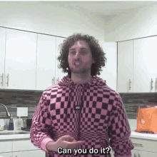 a man in a pink and black checkered hoodie is asking " can you do it "