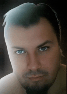 a close up of a man 's face with a beard