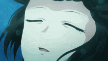 a close up of a woman 's face in the water with her eyes closed