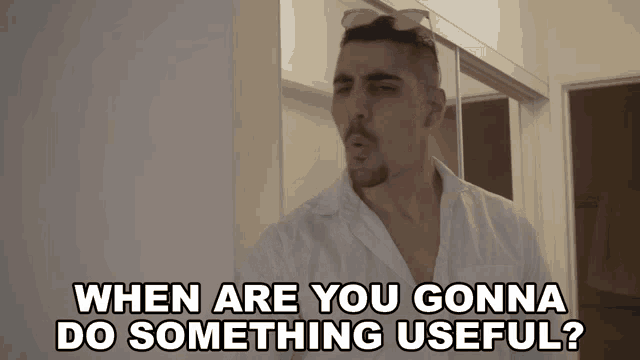 a man in a white shirt with sunglasses on his head says 