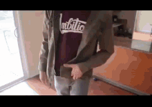 a person wearing a t-shirt that says ambitio
