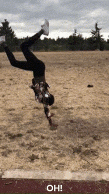 a person is doing a handstand in a field with the words oh on the bottom right