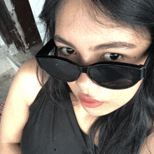 a close up of a woman wearing sunglasses