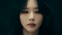 a close up of a woman 's face with a serious look on her face