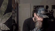 a man with a beard is wearing a hat that says innox disc golf