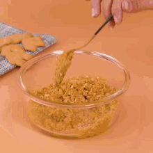 a person is holding a bowl of food that looks like a crumble