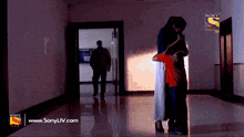 an ad for sony liv shows a woman hugging a child in a dark hallway