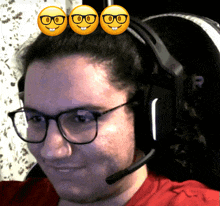 a man wearing glasses and a headset has three smiley faces on his head