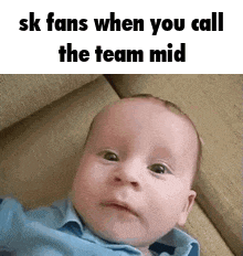 a baby is laying on a couch and making a funny face with the words `` sk fans when you call the team mid ''