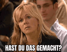 a woman sitting in a crowd with the words hast du das gemacht