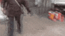 a blurry picture of a person walking down a street with a bag that says coca cola on it