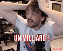 a man in a white shirt holds his hands to his head and says " un milliard "