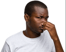 a man is covering his nose with his hand