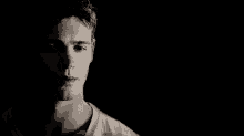 a close up of a man 's face with a black background