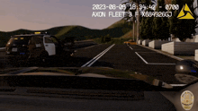a screenshot of a video game shows a police car driving down a highway