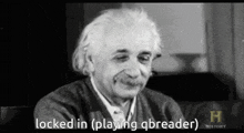 a black and white photo of albert einstein sitting on a couch