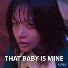 a close up of a woman 's face with the words that baby is mine written below her