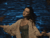 a woman in a white sweater is dancing with a man giving her a thumbs up