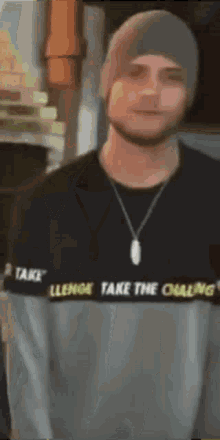 a man wearing a sweater that says take the challenge