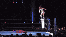 a female wrestler in a ring with a sign that says ' tokyo '