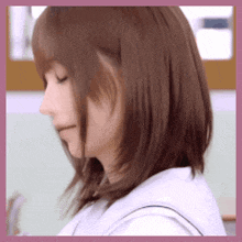 a close up of a woman 's face with a pink border around it