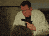a man in a white robe holds a gun in his hand