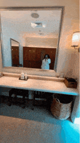 a woman is taking a picture of herself in a mirror