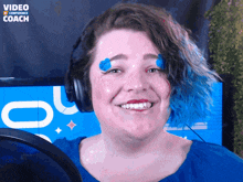 a woman wearing headphones is smiling in front of a video confidence coach logo