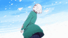 a girl in a green sweater looks up at a blue sky
