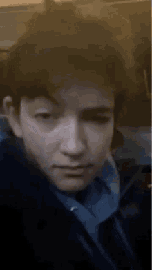 a close up of a young man 's face on a plane .