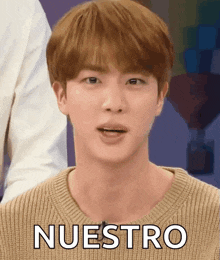 a close up of a person 's face with the word nuestro on it .