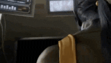 a cartoon character is sitting in front of a computer .