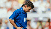 a soccer player wearing a blue jersey with the number 10 on it