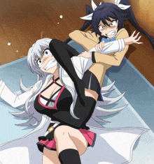 two anime girls are laying on the floor and one is holding the other 's arm