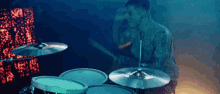 a man is playing the drums in a dark room