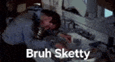 a man is sitting at a kitchen counter with his head in a sink and a caption that says bruh sketty .