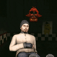 a man is sitting in a dark room with a picture of a yellow bear behind him