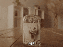 a person is holding a bottle with a picture of a man playing a guitar in it and the word me written on it
