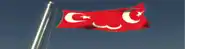 a red and white flag with a star and crescent moon
