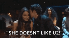 a man and a woman are sitting next to each other in a crowd at a concert .