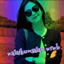 a woman wearing sunglasses stands in front of a colorful background that says ' awalikum salam wrwb '