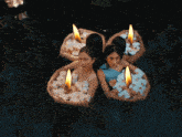 three women are floating in the water with flowers
