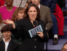 a woman holding a sign that says ricky on it