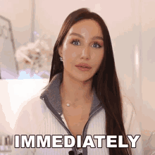 a woman with long hair says immediately in front of her face