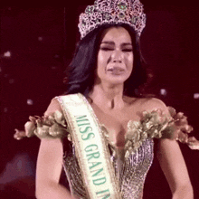 a woman is wearing a crown and a miss grand prix sash .