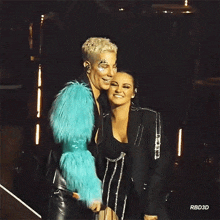a man in a blue fur coat is standing next to a woman in a black dress ..