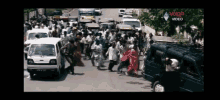 a video shows a crowd of people walking down a street with a volpa video logo in the corner