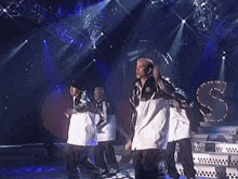 a man in a black and white adidas jacket is dancing